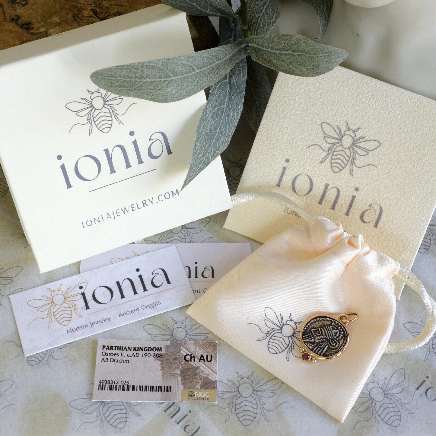 Ancient coin with Pink Sapphire and Ionia packaging