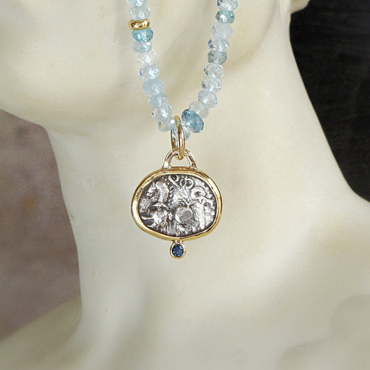 Ancient Celtic coin pendant with blue sapphire hanging on Aquamarine bead necklace with gold